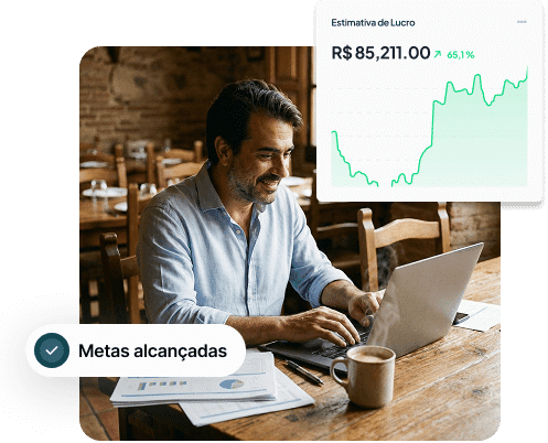 Homem trabalhando em um laptop em uma mesa com café, um gráfico que mostra o crescimento dos lucros e uma notificação que diz "Metas alcançadas" na tela.
